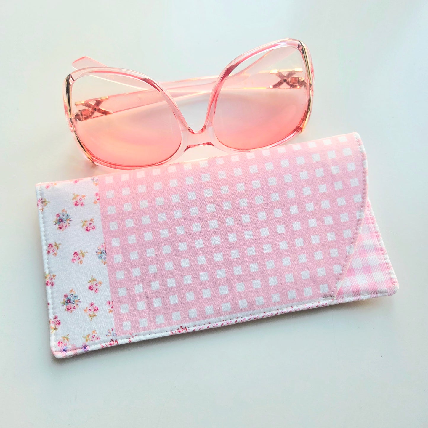 Pink and white checkered case with floral corners.