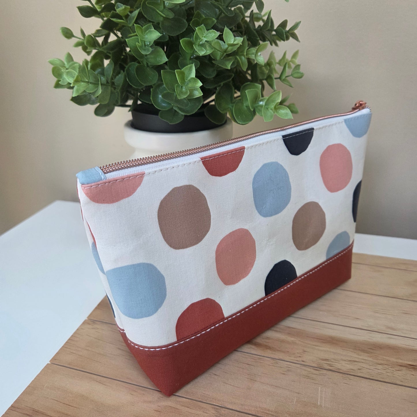 Handmade cotton zipper pouch with multicolour dot pattern and contrast base, perfect for makeup or travel organization