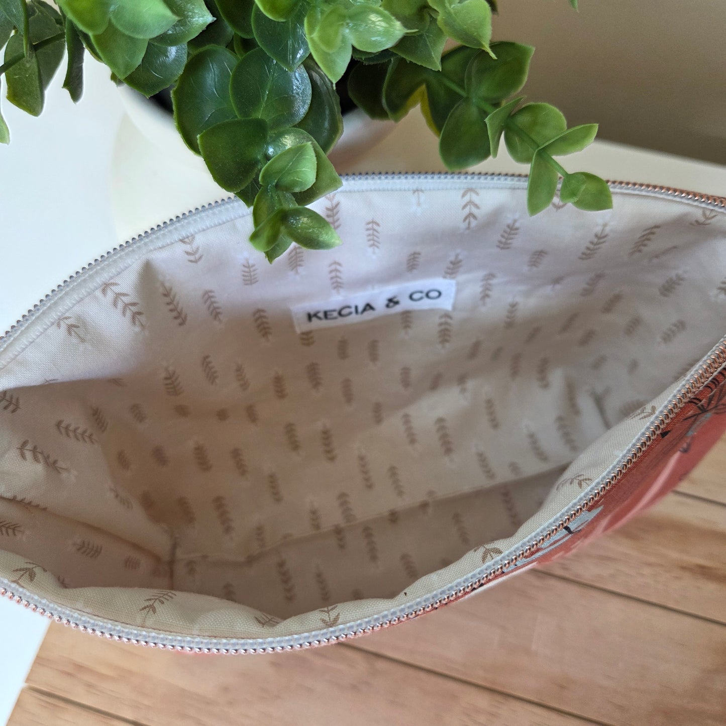 Handmade terracotta pouch open to show interior lining and spacious compartment