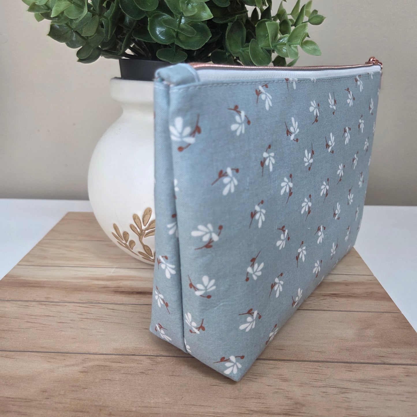 Handmade fabric pouch with soft blue floral cotton and zipper closure