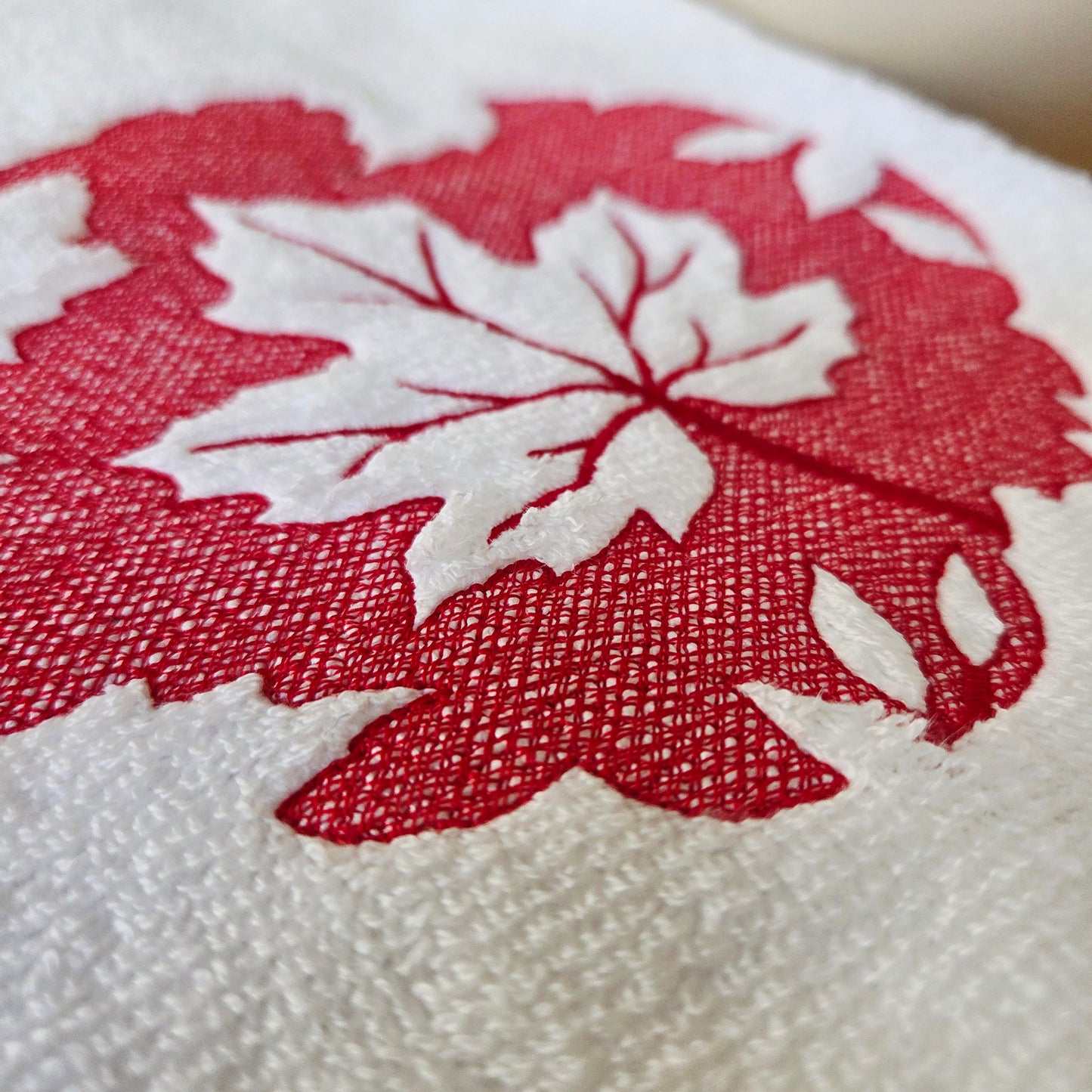 Autumn-inspired embroidered maple leaf towel in red
