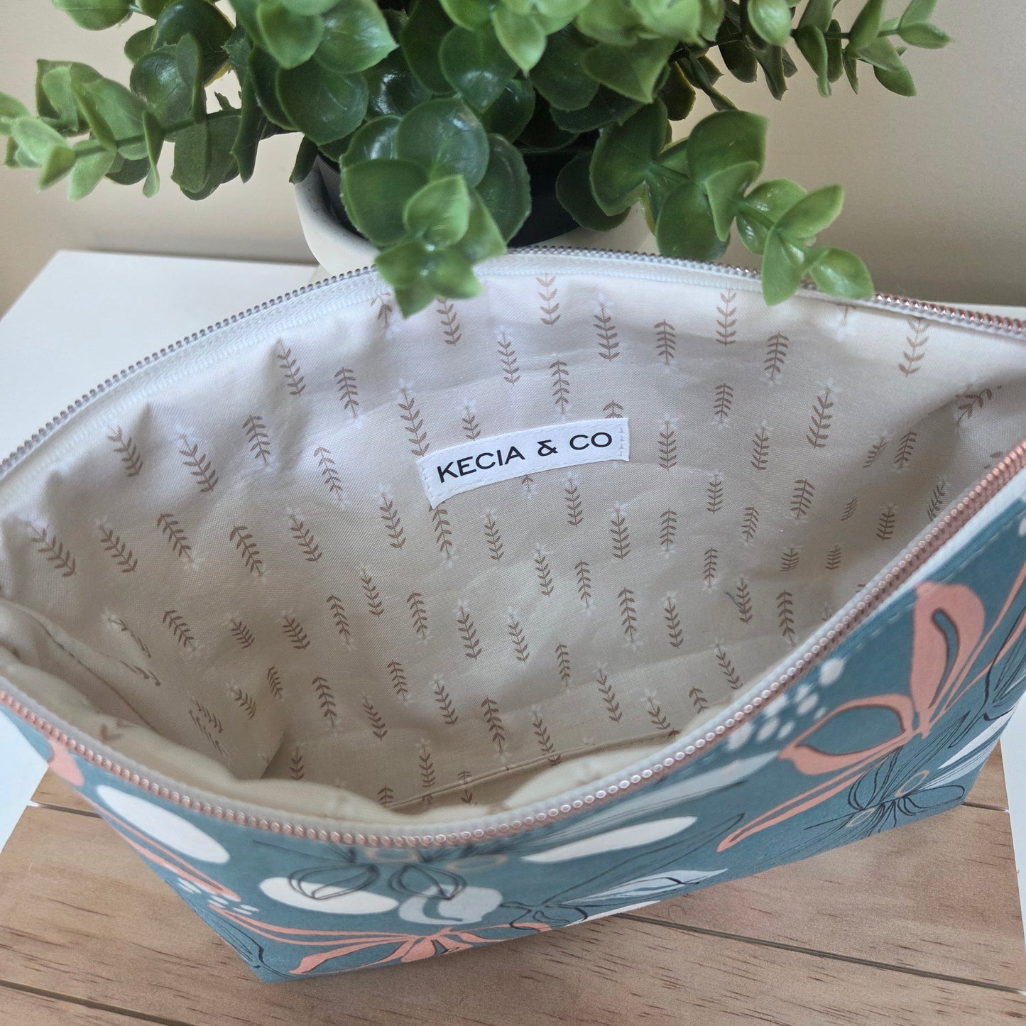 Open view of the handmade Seafoam Petals pouch showing interior lining