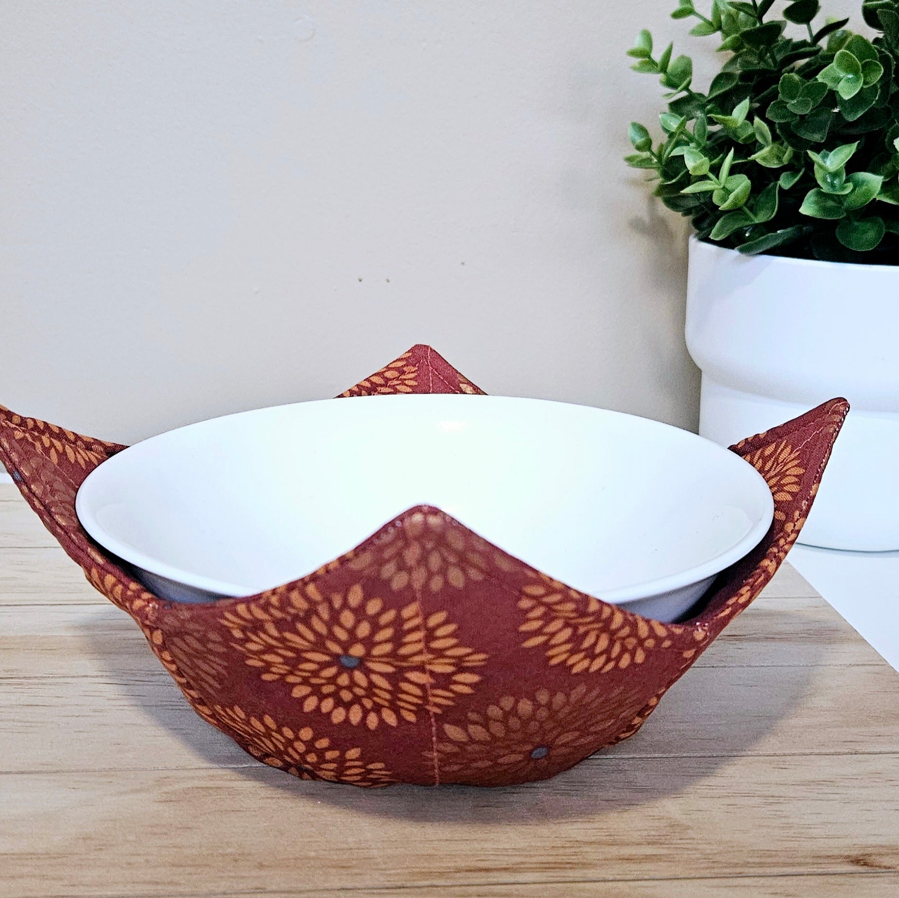 Handmade bowl cozy featuring warm autumn tones and harvest-inspired fabric, perfect for fall meals
