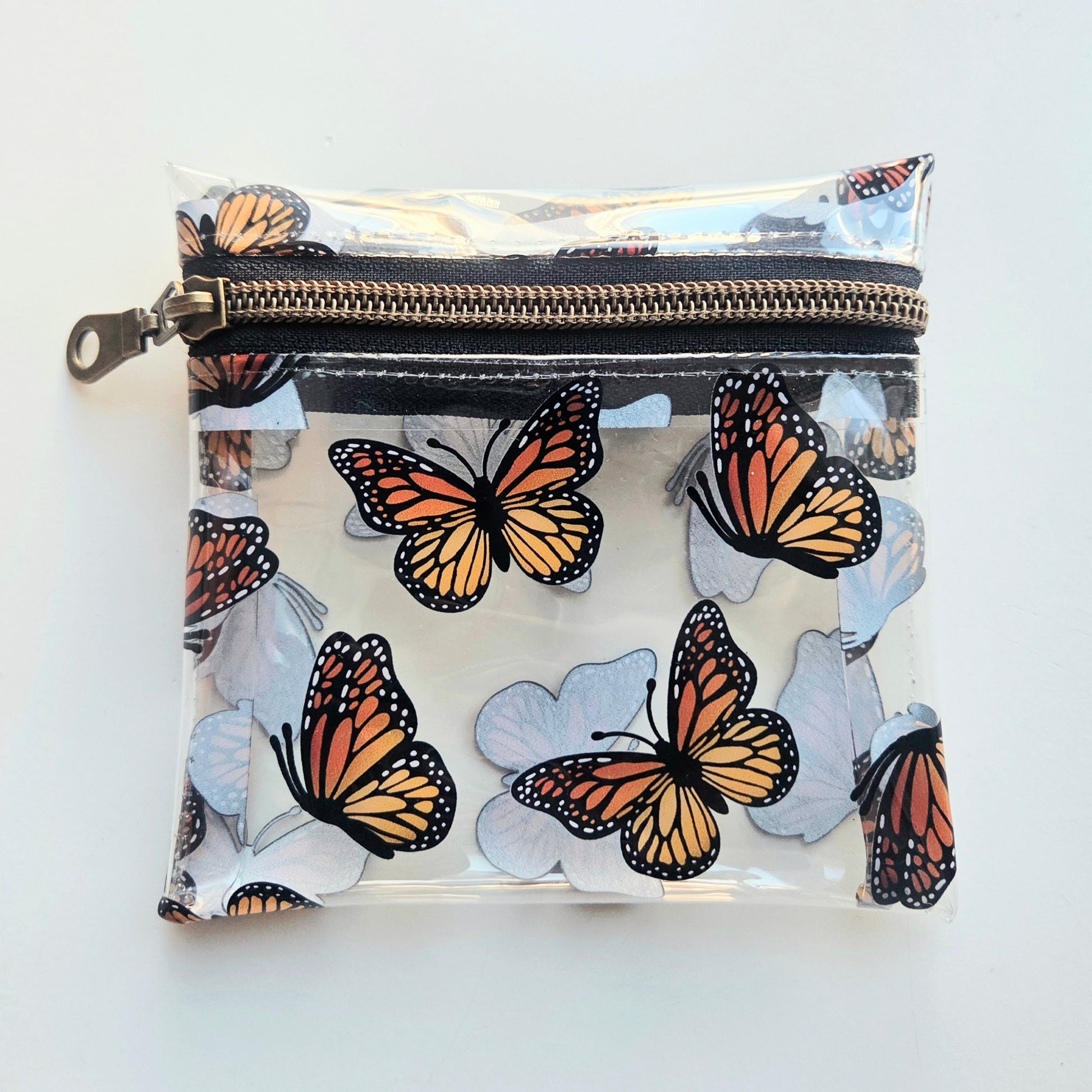 Clear pouch with butterfly design and black zipper 