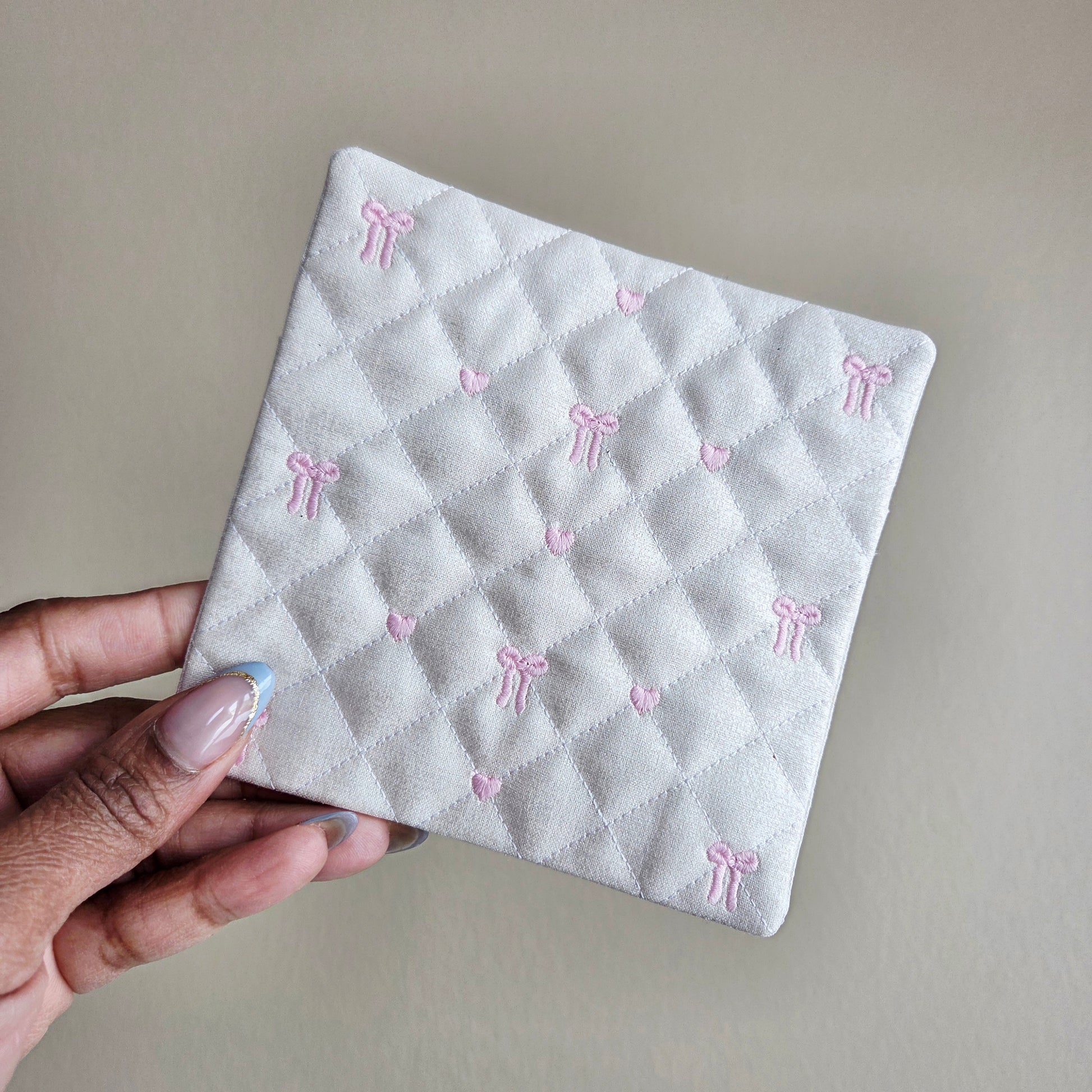 Cream quilted fabric coaster with pink bow embroidery, handmade Valentine coffee coaster
