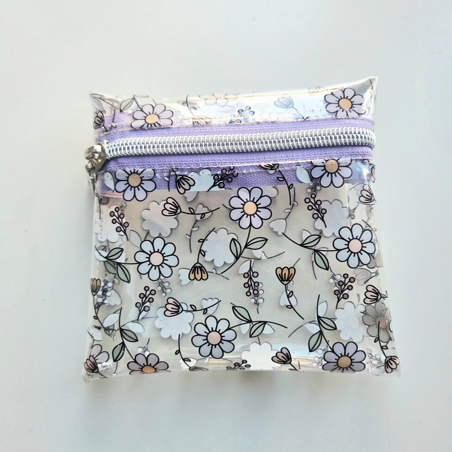 Clear pouch with floral pattern and purple zipper