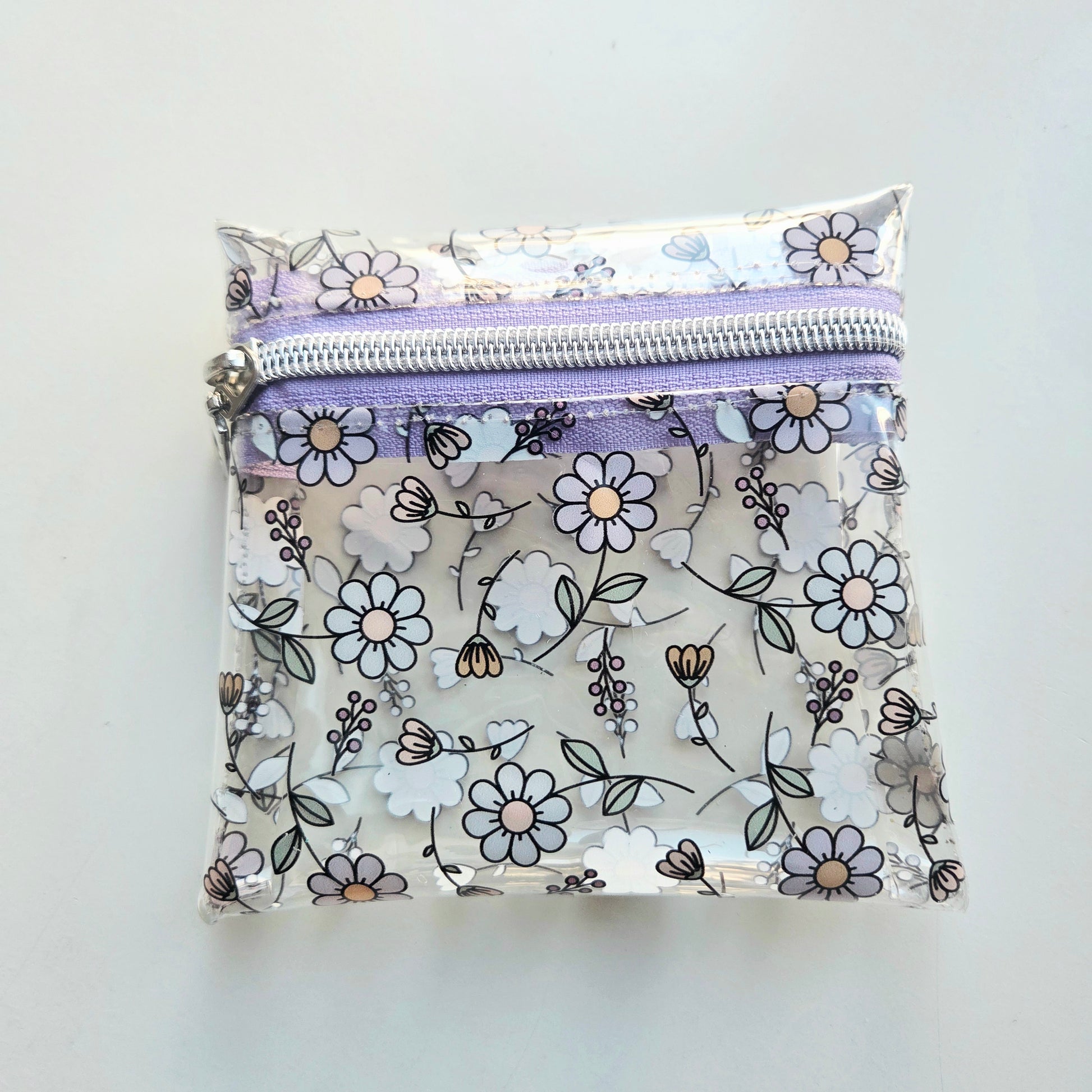 Clear pouch with floral pattern and purple zipper