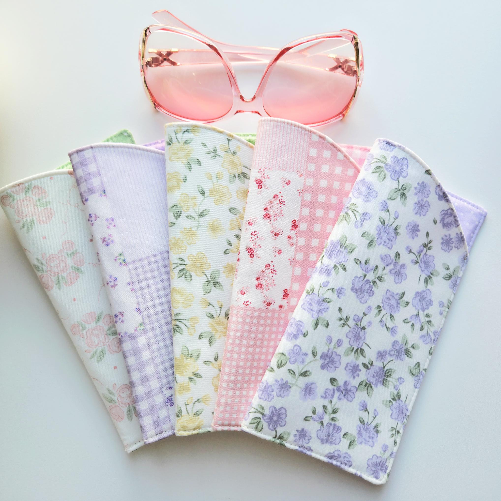 Set of floral fabric swatches with a pink sunglasses on a light background