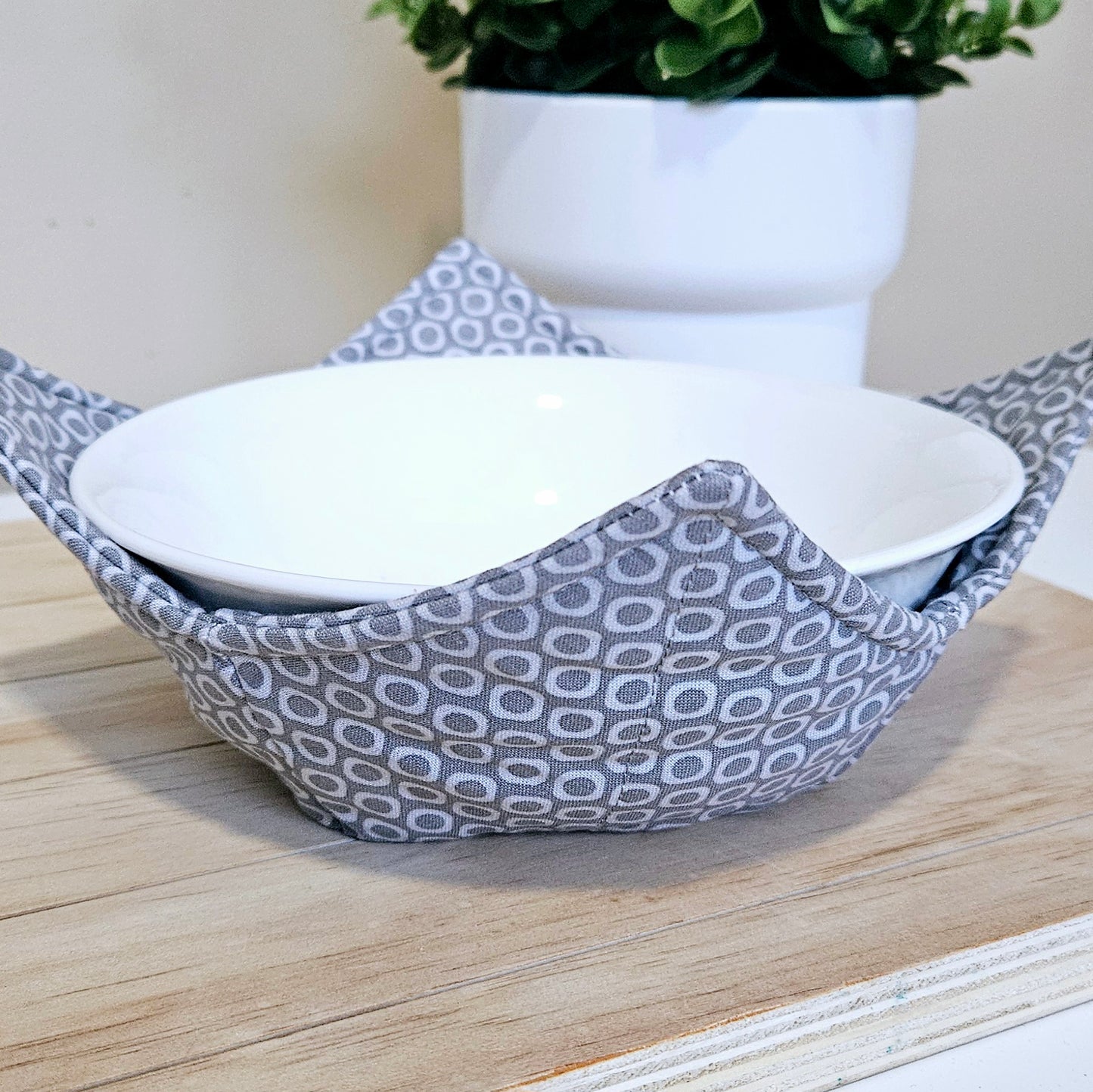 Handmade fabric bowl cozy with quilted stitching, perfect for hot bowls and microwave use