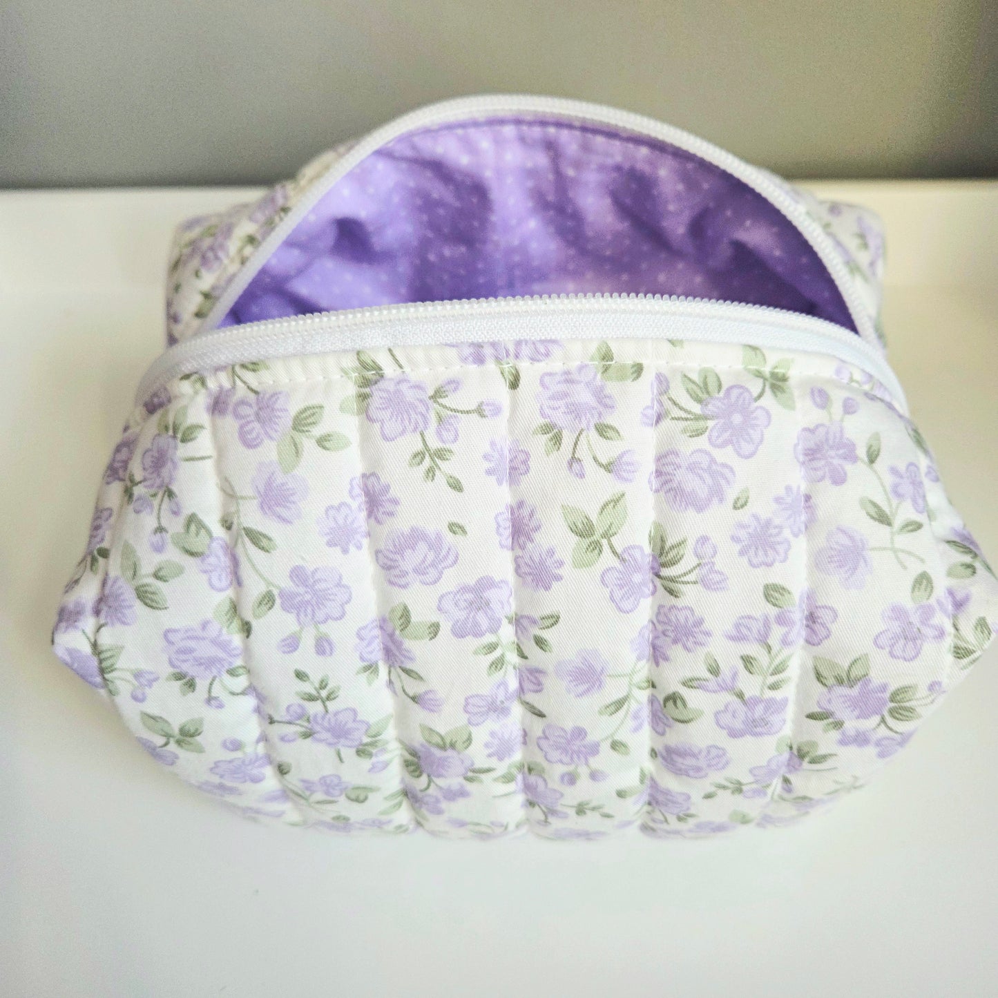 Floral-patterned pouch with a purple interior
