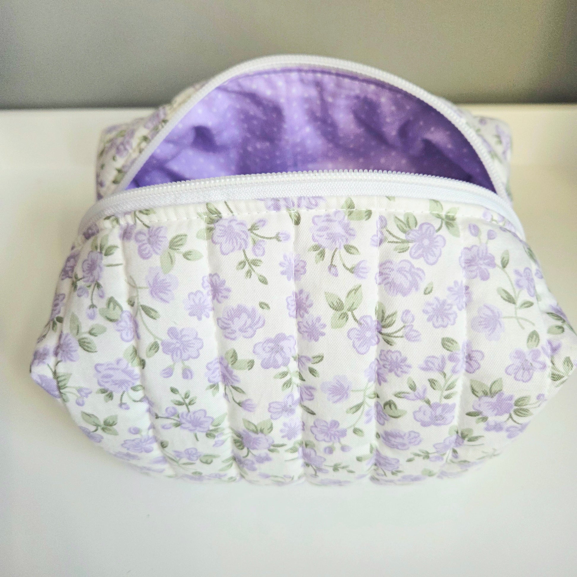 Floral-patterned pouch with a purple interior