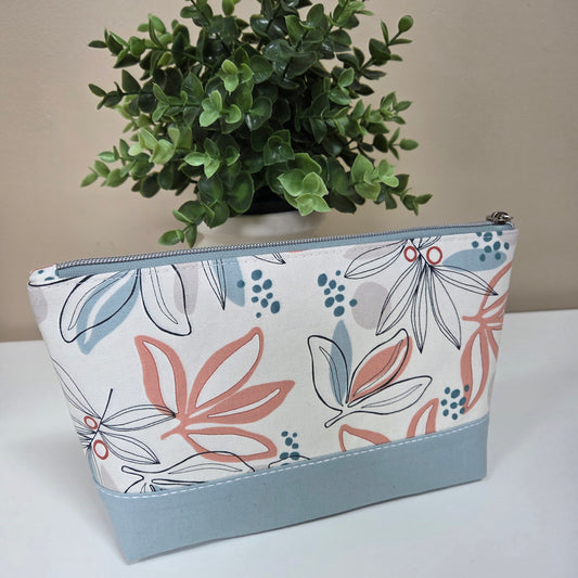 Handmade floral zipper pouch with blue background