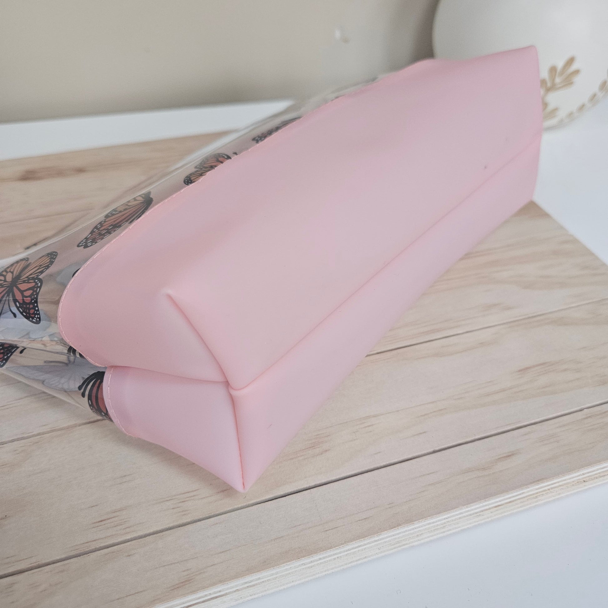 Detail of base on butterfly clear toiletry bag