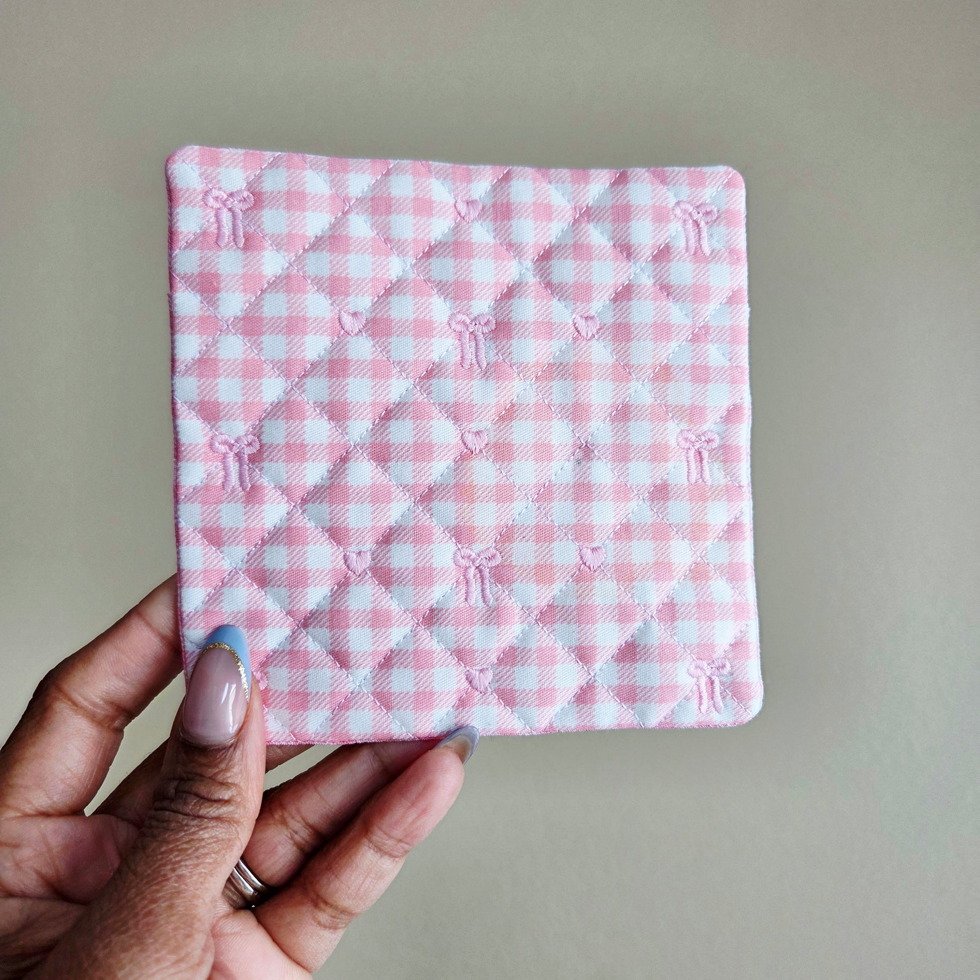 Pink gingham quilted fabric coaster with embroidered bow detail, handmade Valentine mug rug