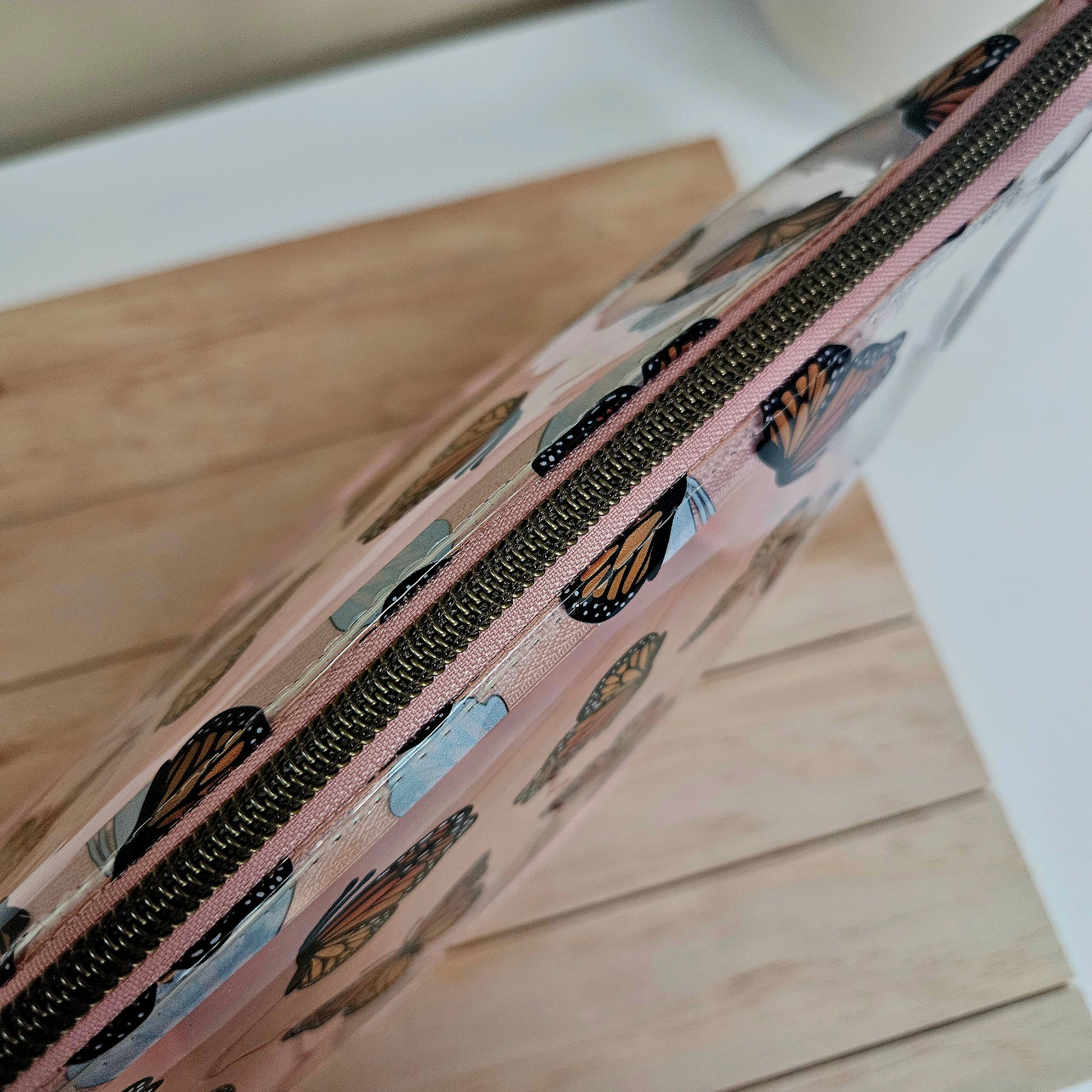 Handmade transparent makeup bag with butterflies and blush pink bottom