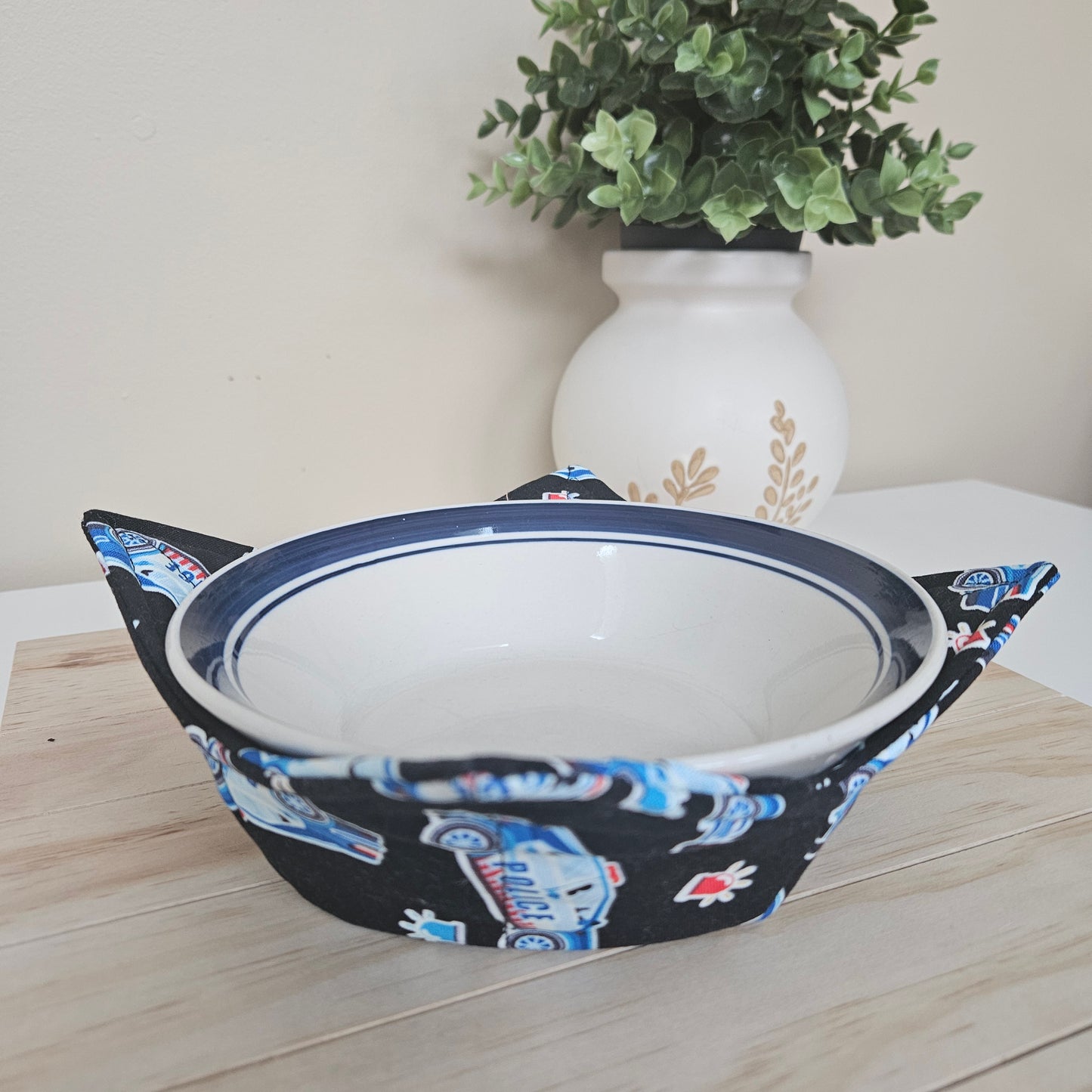 Handmade cotton bowl cozy with police-themed fabric, featuring badges, cruisers, and blue tones