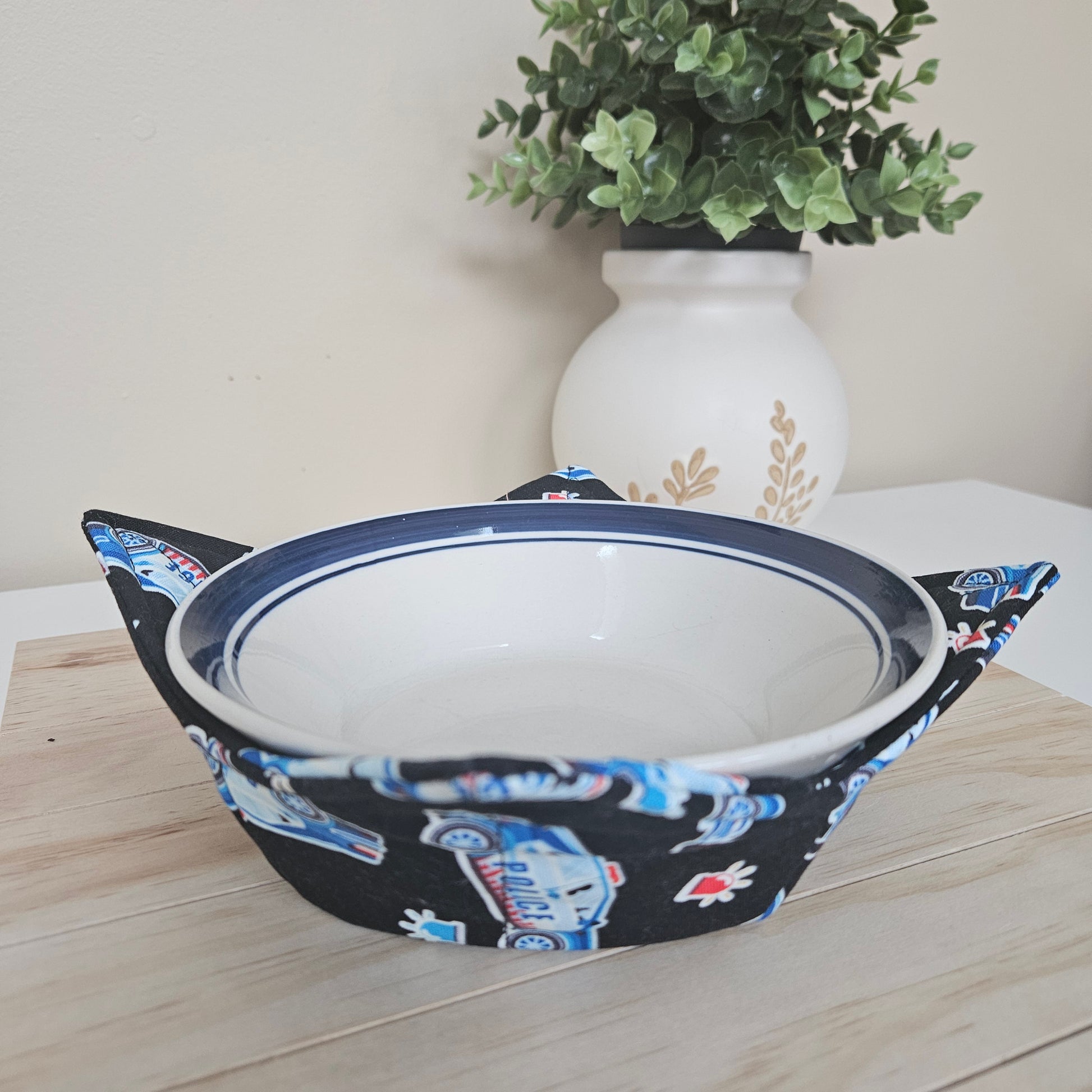 Handmade cotton bowl cozy with police-themed fabric, featuring badges, cruisers, and blue tones