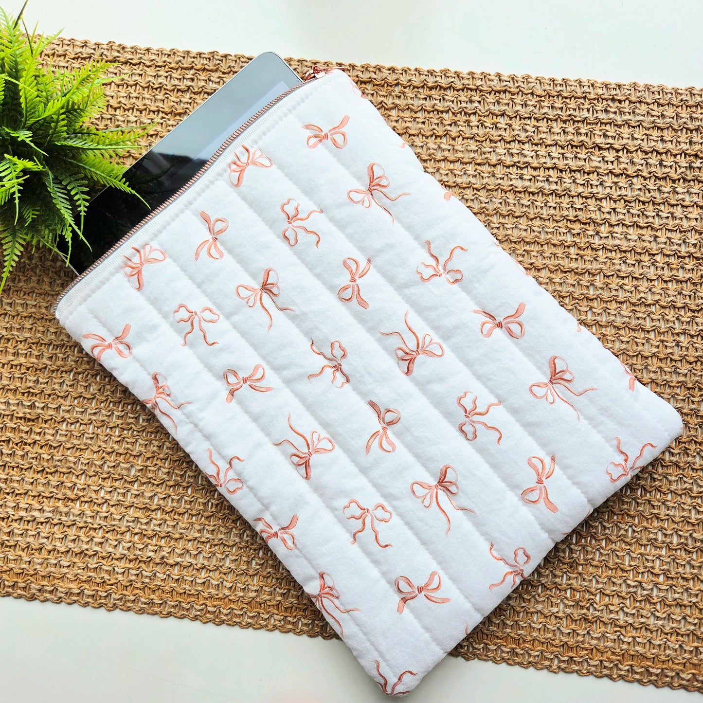 Handmade quilted iPad sleeve in blush bow fabric