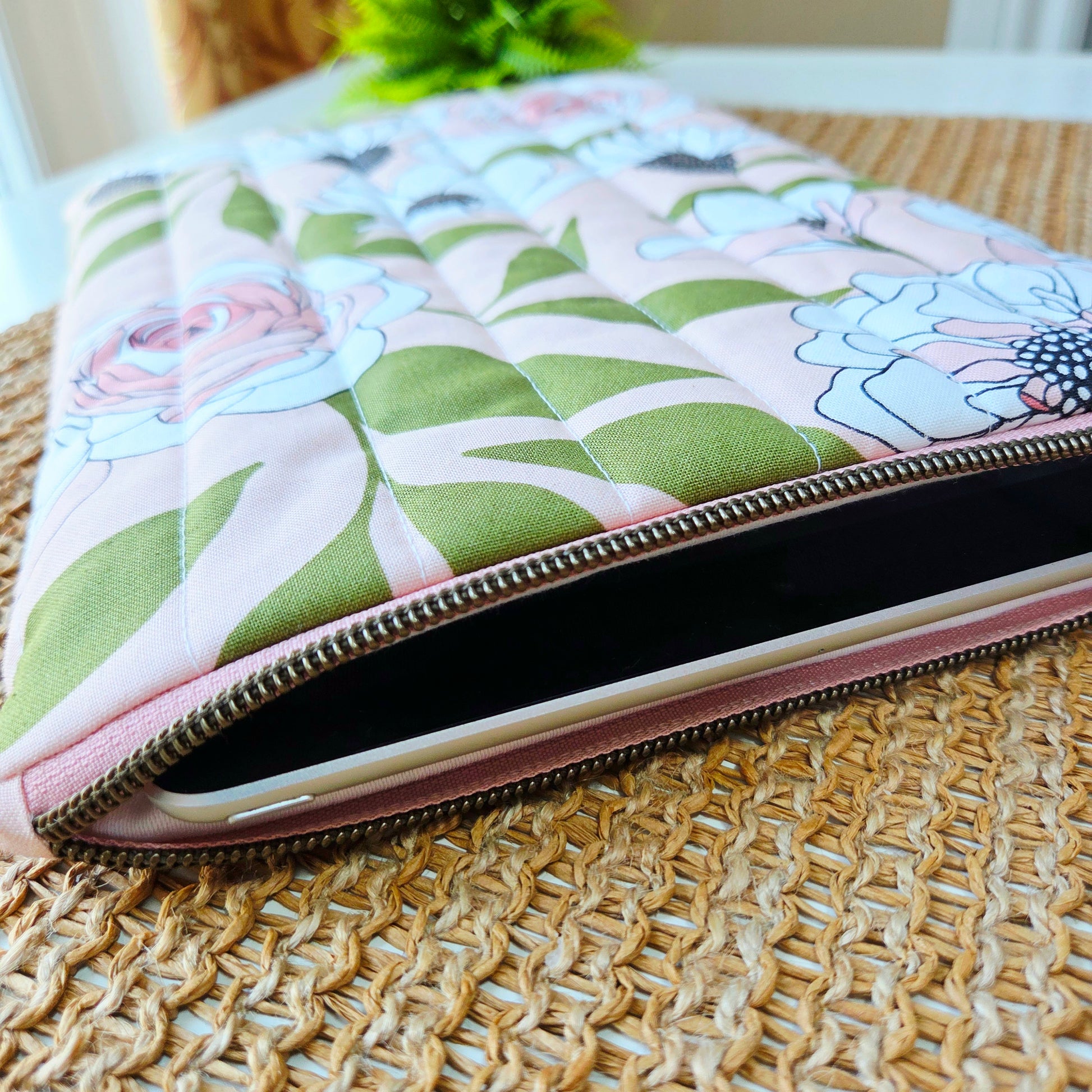 Quilted iPad sleeve with blush pink floral fabric, handcrafted with soft padding and zipper closure for stylish tablet protection