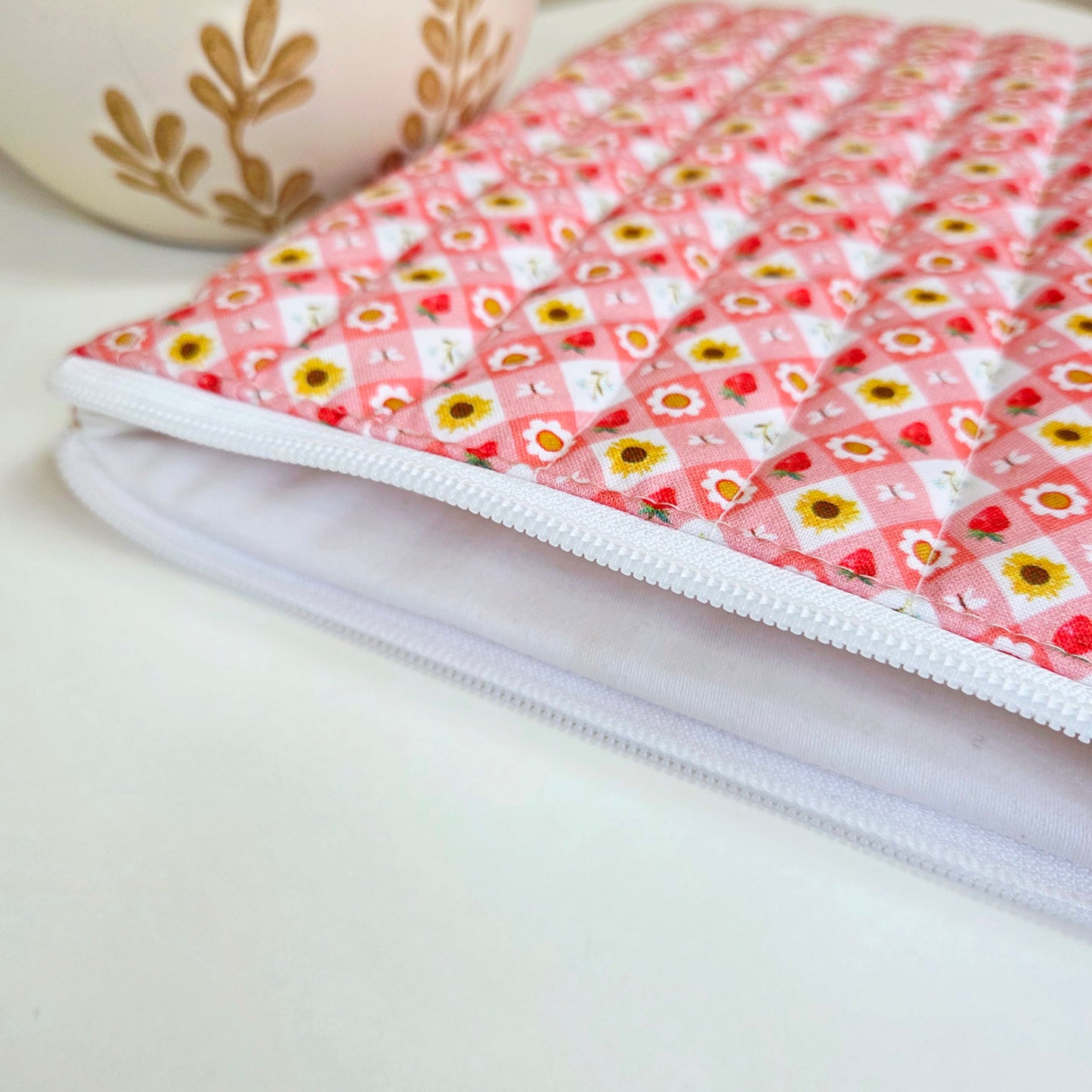 Side view of handmade pink tablet cover with white zipper