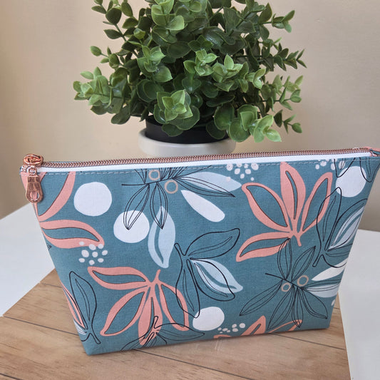 Front view of the Seafoam Petals zipper pouch with coral and white floral print