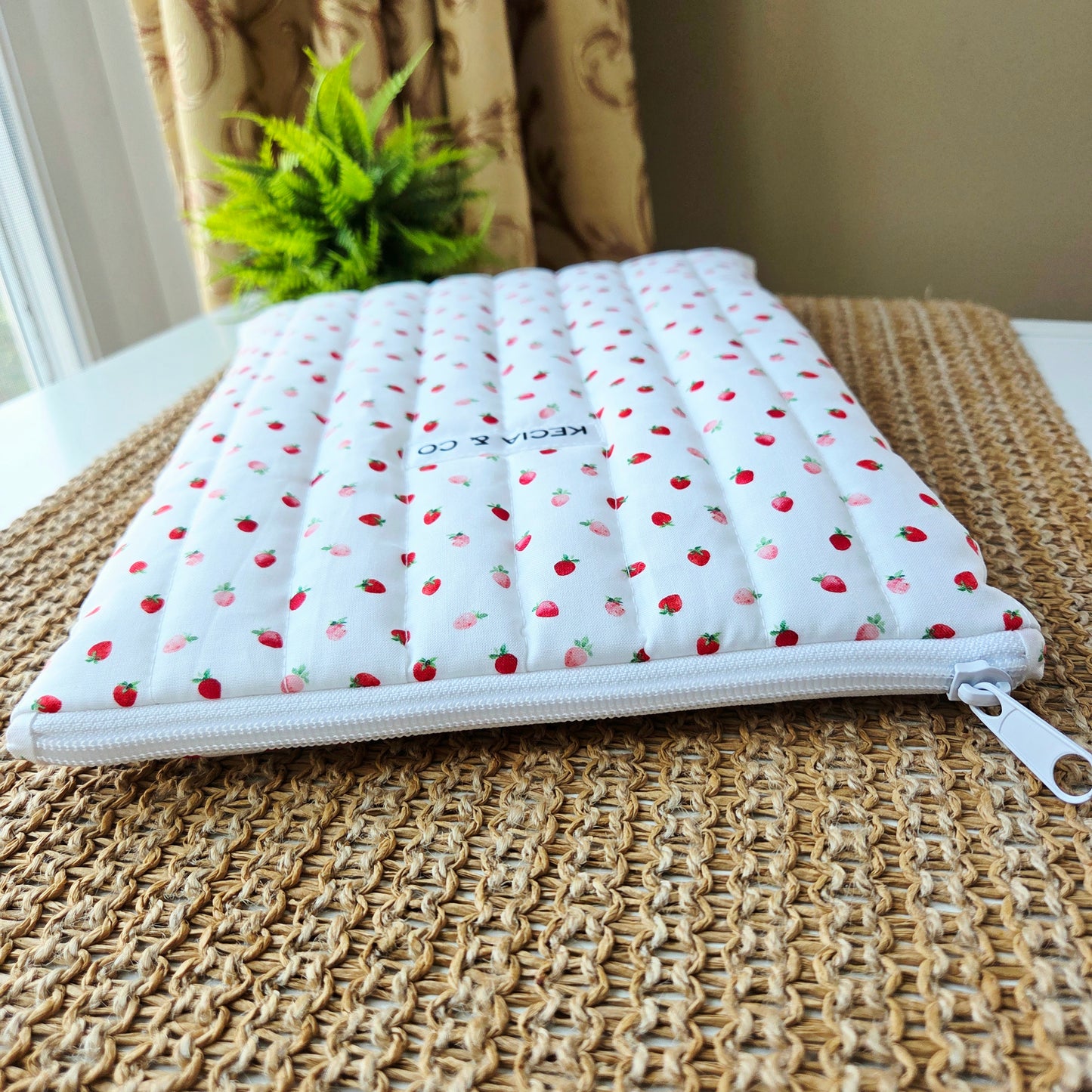 Quilted iPad case with playful red strawberry print on pink fabric, handmade by Kecia & Co.