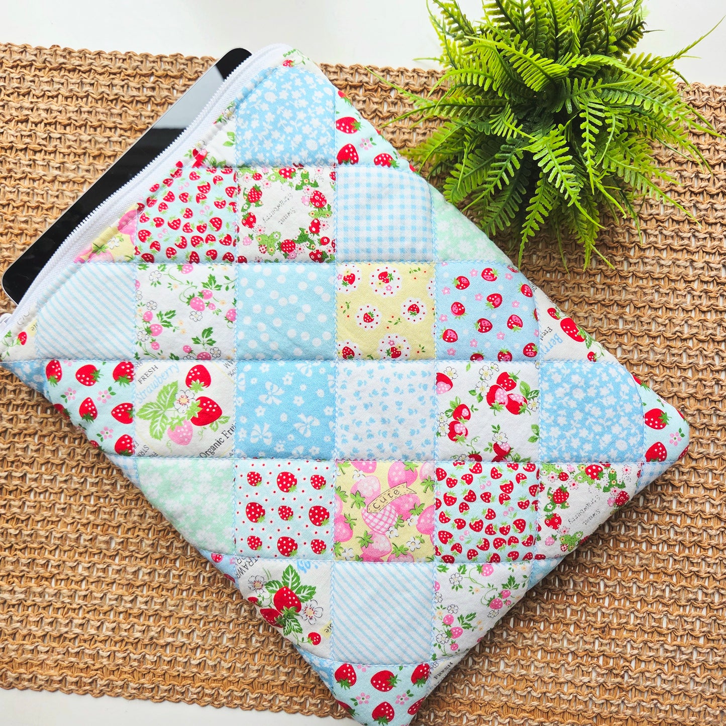 Handmade quilted iPad sleeve in strawberry patchwork fabric